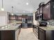 Modern kitchen featuring stainless steel appliances, granite countertops, and dark wood cabinetry at 1470 Lake Side Ave, Davenport, FL 33837