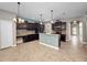 Open kitchen with granite counters, stainless appliances, and stylish pendant lighting at 1470 Lake Side Ave, Davenport, FL 33837