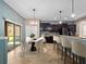 Eat-in kitchen with granite countertops, stainless appliances, and a large sliding glass door at 1470 Lake Side Ave, Davenport, FL 33837