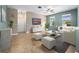 Bright living room with neutral paint, tile floors, ceiling fan and two windows to let in natural light at 1470 Lake Side Ave, Davenport, FL 33837