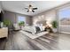 Staged main bedroom featuring decorative plants, ceiling fan, two windows with curtains, and modern decor at 1470 Lake Side Ave, Davenport, FL 33837