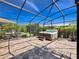 Spacious screened patio featuring a hot tub, perfect for relaxation and entertaining at 1470 Lake Side Ave, Davenport, FL 33837