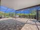 Screened patio boasts ample space with a hot tub overlooking the beautiful yard at 1470 Lake Side Ave, Davenport, FL 33837