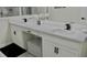 This bathroom features a dual sink vanity with white cabinets and quartz countertops at 1508 Bunker Drive Bunker, Davenport, FL 33896