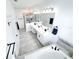 Bright bathroom featuring double vanity, soaking tub, tiled floors, walk-in shower, and sleek black hardware at 1508 Bunker Drive Bunker, Davenport, FL 33896