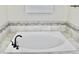 Relaxing soaking tub with elegant fixtures and tiled surround, creating a spa-like atmosphere at 1508 Bunker Drive Bunker, Davenport, FL 33896