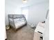This bright bedroom features a gray bunk bed, plush carpet, and neutral decor, creating a cozy and inviting atmosphere at 1508 Bunker Drive Bunker, Davenport, FL 33896