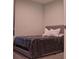 This bedroom features a comfy looking bed with neutral colors and carpeted floors at 1508 Bunker Drive Bunker, Davenport, FL 33896