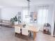 Light-filled dining area with modern light fixture and dining table with seating at 1508 Bunker Drive Bunker, Davenport, FL 33896