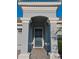 This home features a welcoming, arched front entry with stately columns and a beautifully tiled walkway leading to a dark blue front door at 1508 Bunker Drive Bunker, Davenport, FL 33896