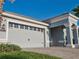 Garage detail showcasing the large garage door with decorative windows and black hardware, framed by mature landscaping at 1508 Bunker Drive Bunker, Davenport, FL 33896