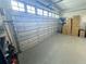 An open garage with a clean epoxy floor and an automatic door opener to park your car inside at 1508 Bunker Drive Bunker, Davenport, FL 33896