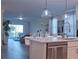 Open concept kitchen with stainless steel appliances, white cabinetry, quartz countertops, and pendant lighting at 1508 Bunker Drive Bunker, Davenport, FL 33896