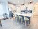 Bright kitchen features a large island, stainless steel appliances, white cabinets and a breakfast bar at 1508 Bunker Drive Bunker, Davenport, FL 33896