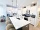 Modern kitchen featuring a large island with seating, stainless steel appliances, and white cabinetry at 1508 Bunker Drive Bunker, Davenport, FL 33896