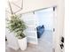 Living room featuring a modern sliding door, a plant, and a comfortable blue sofa at 1508 Bunker Drive Bunker, Davenport, FL 33896