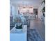 Open-concept living room showcasing wood floors, stylish decor, and a view of the adjacent modern kitchen at 1508 Bunker Drive Bunker, Davenport, FL 33896