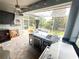 This outdoor kitchen includes a grill, cooler, and a covered seating area overlooking the backyard and lake at 1508 Bunker Drive Bunker, Davenport, FL 33896