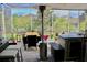 Relaxing screened patio featuring an outdoor kitchen, dining set, and comfortable seating area at 1508 Bunker Drive Bunker, Davenport, FL 33896