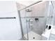 Walk-in shower featuring sleek glass enclosure, gray tile, modern fixtures, and a built-in niche for toiletries at 1508 Bunker Drive Bunker, Davenport, FL 33896