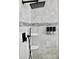 This shower features gray tiling with black fixtures and convenient built in soap and shampoo dispensers at 1508 Bunker Drive Bunker, Davenport, FL 33896