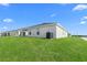 Large backyard with lush green grass surrounds a well-maintained home exterior at 1524 Fleur Dr, Davenport, FL 33837