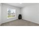 Bright bedroom featuring a window and neutral carpet, ready for personalization at 1524 Fleur Dr, Davenport, FL 33837