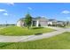 Well-maintained single-story home featuring a lush lawn and a welcoming entrance at 1524 Fleur Dr, Davenport, FL 33837