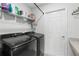 Functional laundry room with modern washer and dryer, shelving, and ample storage at 1524 Fleur Dr, Davenport, FL 33837