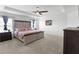 Spacious main bedroom with a tray ceiling, carpet, and large bed at 1524 Fleur Dr, Davenport, FL 33837