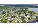 Aerial view showcasing a charming lakeside community with lush greenery and well-spaced homes at 1626 Gar St, St Cloud, FL 34771