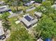 Aerial view showing home with solar panels nestled among mature trees in a residential area at 1626 Gar St, St Cloud, FL 34771