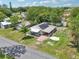 Aerial view of a home with solar panels, a porch, and a detached garage in a green neighborhood at 1626 Gar St, St Cloud, FL 34771