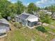 Aerial view of the solar panel-equipped home with fenced yard and inviting front porch at 1626 Gar St, St Cloud, FL 34771
