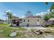 Exterior rear view of home with a screened-in patio and backyard at 1626 Gar St, St Cloud, FL 34771