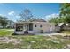 Exterior rear view of home with screened-in patio and small yard at 1626 Gar St, St Cloud, FL 34771