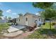 Back of house with a small patio, generator and yard at 1626 Gar St, St Cloud, FL 34771