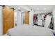 Bedroom featuring a sliding barn door closet providing easy access and rustic charm at 1626 Gar St, St Cloud, FL 34771