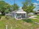 Aerial view of a cozy home with a covered porch and carport surrounded by greenery at 1626 Gar St, St Cloud, FL 34771