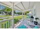 Cozy front porch with seating area, overlooking a green lawn and quiet street at 1626 Gar St, St Cloud, FL 34771