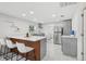 Bright and modern kitchen with a central island, stainless steel appliances, and sleek cabinets at 1626 Gar St, St Cloud, FL 34771