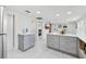 Spacious kitchen featuring stainless steel appliances, white countertops and sleek gray cabinetry at 1626 Gar St, St Cloud, FL 34771