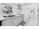 Well-lit kitchen featuring stainless steel appliances, white countertops, and sleek gray cabinetry at 1626 Gar St, St Cloud, FL 34771