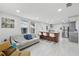 Open-concept living room with modern lighting, stylish furnishings, and seamless flow into the kitchen at 1626 Gar St, St Cloud, FL 34771