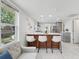 Bright living room featuring a modern kitchen island with bar stool seating at 1626 Gar St, St Cloud, FL 34771