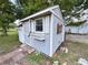 Exterior view of a cute shed with window box, offering extra storage at 1626 Gar St, St Cloud, FL 34771