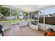 Enclosed sunroom needing repairs offers indoor-outdoor living potential and natural light at 1626 Gar St, St Cloud, FL 34771