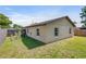 Spacious fenced backyard featuring manicured grass, a garden bed, and a block home at 1712 Melvin Ave, Orlando, FL 32806