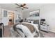 Well-appointed bedroom including a desk and view into the kitchen, decorated with neutral colors and a ceiling fan at 1712 Melvin Ave, Orlando, FL 32806