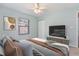 Modern bedroom featuring a TV, neutral walls, a ceiling fan, and window with blinds, creating a cozy space at 1712 Melvin Ave, Orlando, FL 32806